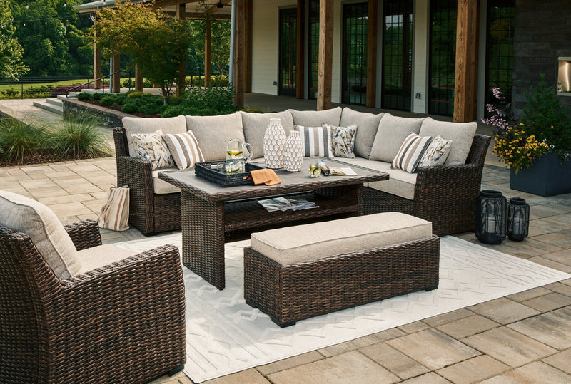 Brook Ranch Outdoor Sectional Set with Lounge Chair and Coffee Table in Brown from Ashley - Lara Furniture