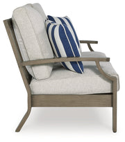 Rainier Ranch Outdoor Loveseat and 2 Chairs with Coffee Table in Brown/Beige from Ashley - Lara Furniture