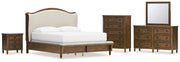 Sturlayne California King Upholstered Panel Bed with Mirrored Dresser, Chest and Nightstand in Brown from Ashley - Lara Furniture