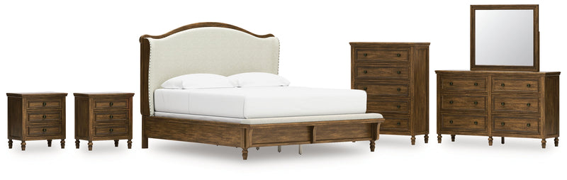 Sturlayne King Upholstered Panel Bed with Mirrored Dresser, Chest and 2 Nightstands in Brown from Ashley - Lara Furniture