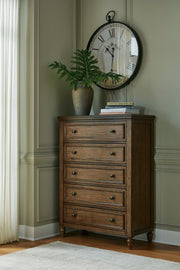 Sturlayne Queen Upholstered Panel Bed with Mirrored Dresser and Chest in Brown from Ashley - Lara Furniture