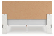 Zuraleus King Upholstered Panel Platform Bed, Dresser and Nightstand in White - PKG022822